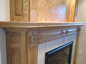 Closeup view of cut-out details in a custom wooden fireplace design