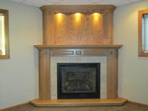 Floor-to-ceiling light wood fireplace built-in with recessed lighting