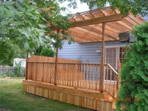 Custom wooden porch & pergola on side of a house