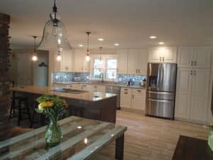 Full view of freshly remodeled kitchen with white cabinets & stainless-steel appliances