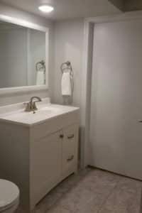 ‘After’ picture of modern white basement bathroom remodel