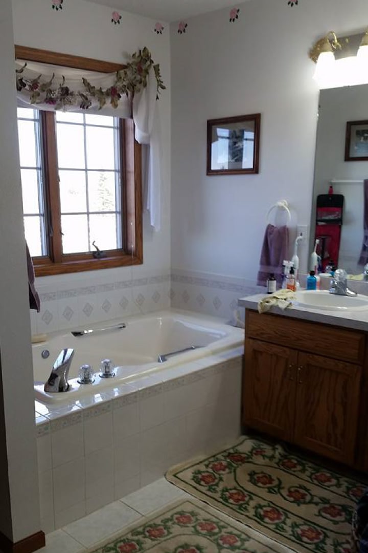 Before picture of outdated bathroom with bathtub & sink