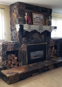Custom floor-to-ceiling large mixed stone fireplace