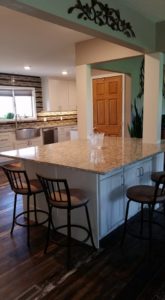 Remodeled kitchen with granite countertops and large island.