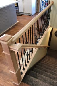 ‘After’ picture of light wood & dark wrought-iron stair railing & handrail