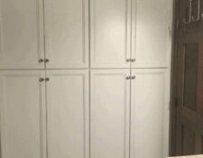 Floor-to-ceiling, tall white recessed bathroom cabinets