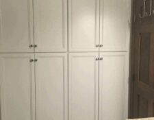 Floor-to-ceiling, tall white recessed bathroom cabinets