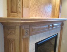 Closeup view of cut-out details in a custom wooden fireplace design