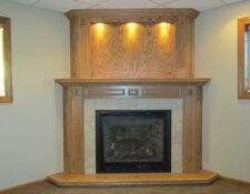 Floor-to-ceiling light wood fireplace built-in with recessed lighting