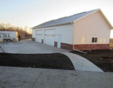 Todd Williams Construction trailer sits on driveway next to finished 2-stall workshop