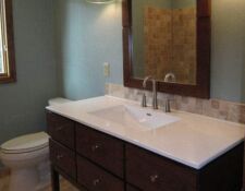 Custom dark brown bathroom console vanity with drawers & white sink