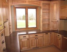 U-shaped room covered in custom built-ins & desk