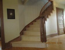 Curved light wood staircase & railing