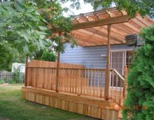 Custom wooden porch & pergola on side of a house