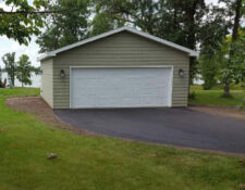 Exterior of 1-car garage with green paint & white garage door