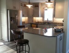 Kitchen remodel with light cabinets & dark granite counters